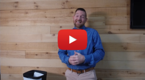 A video still of Project Manager Nathan Bonds smiling with red YouTube play button.