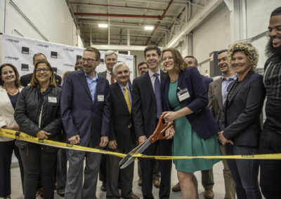 VIPs including JARC's Adonis Summerville, Senator Jack Reed, Senator Sheldon Whitehouse, Mayor Brett Smiley and Commerce Secretary Liz Tanner join in cutting the ribbon at the Grand Opening of JARC Rhode Island on May 19, 2023.