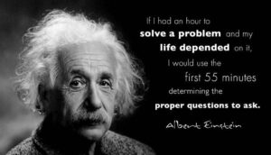 Photo of Albert Einstein with text quote - determine the proper questions to ask