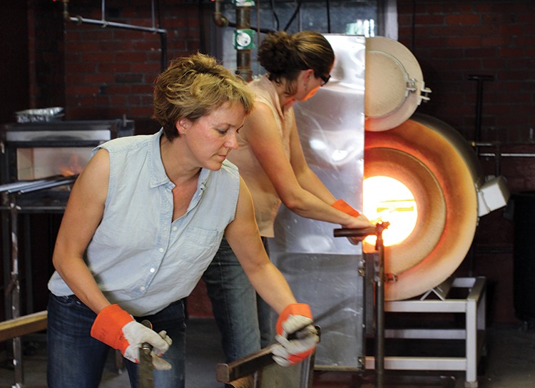 Rhode Island glassblower designer Tracy Glover working in her studio