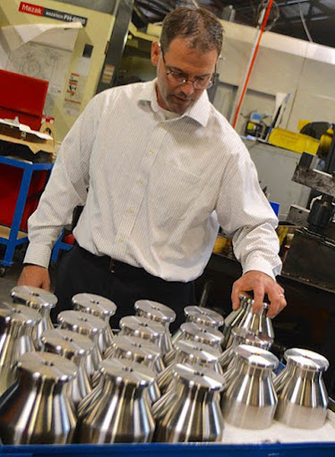Phil McCally of American Tool Company with some of the machining team's parts.