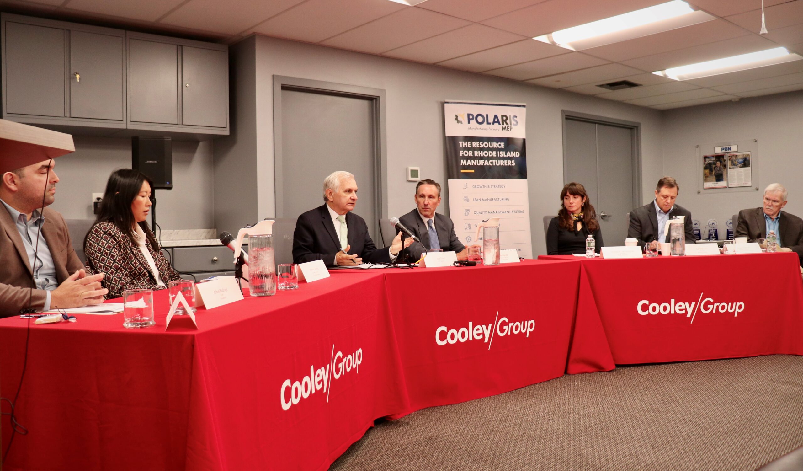 Senator Jack Reed (seated, center) with RI Manufacturers during roundtable discussion at Cooley Group facility in 2024.